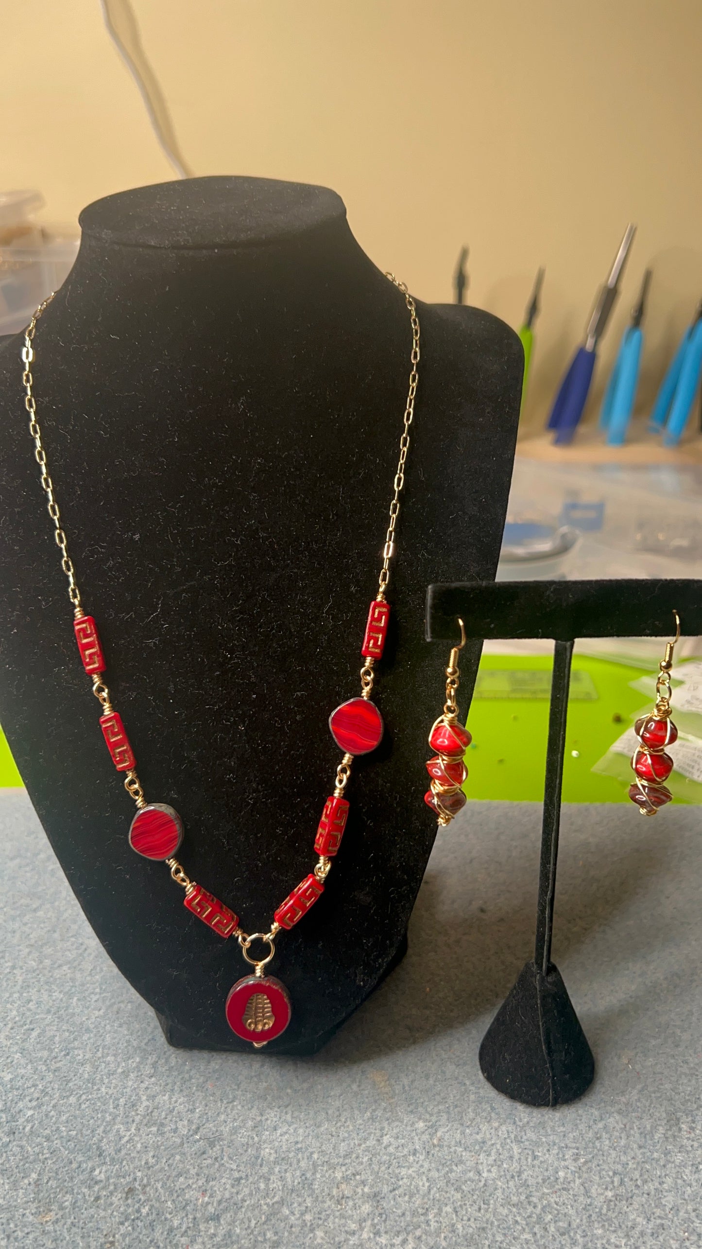 Silky Red with gold and bronze hues Beads with gold chain and matching earrings