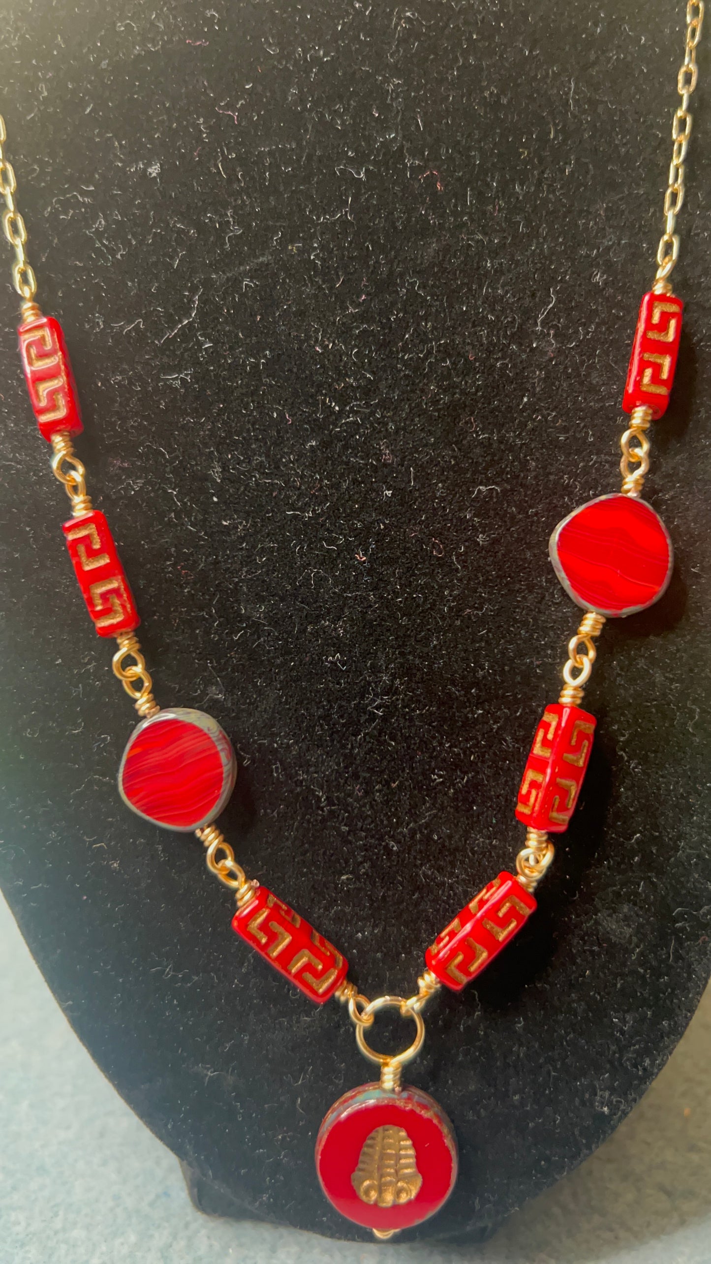 Silky Red with gold and bronze hues Beads with gold chain and matching earrings