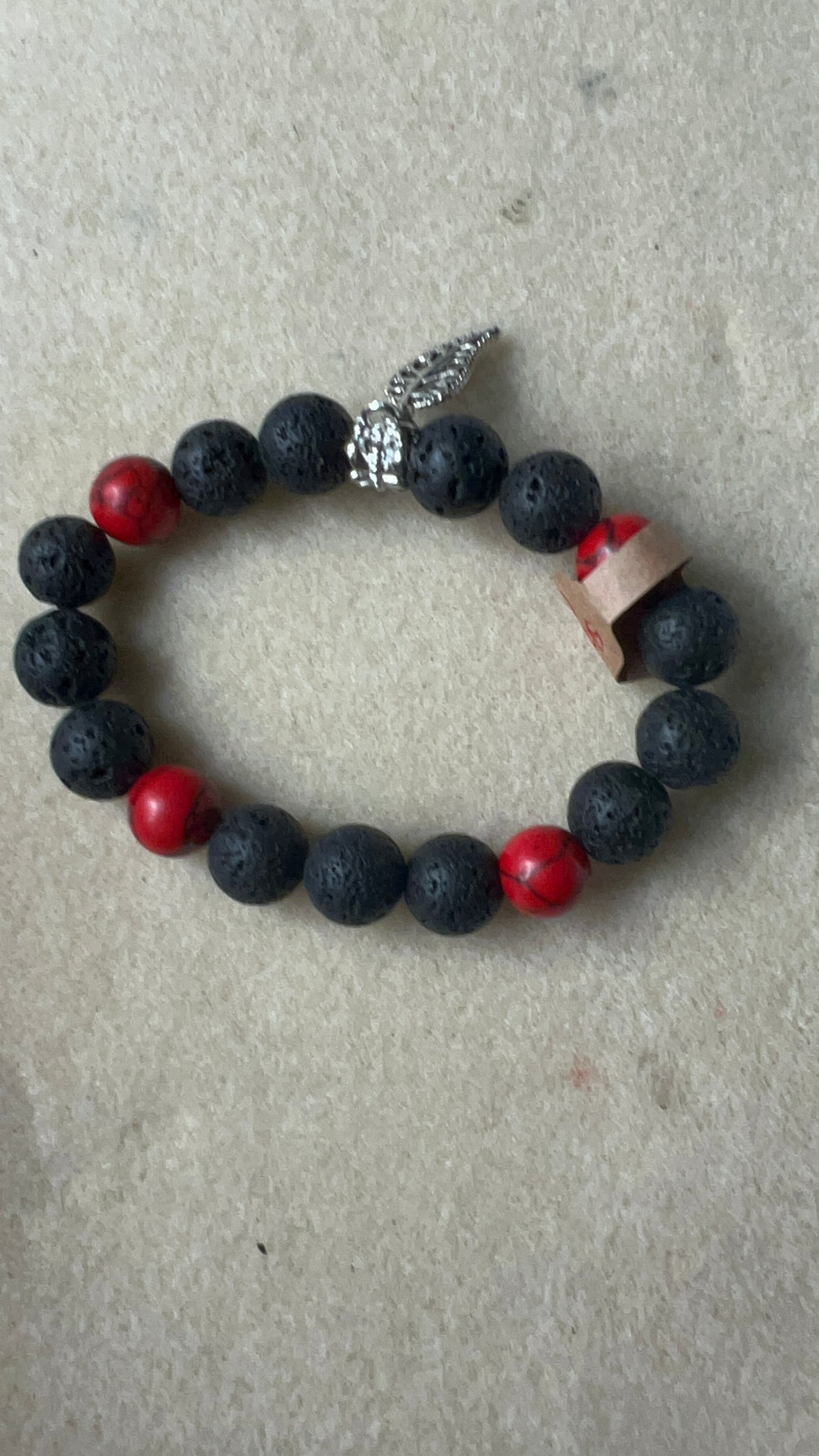 Black lava beads with red crackle beads stretch bracelet with silver leaf pendant