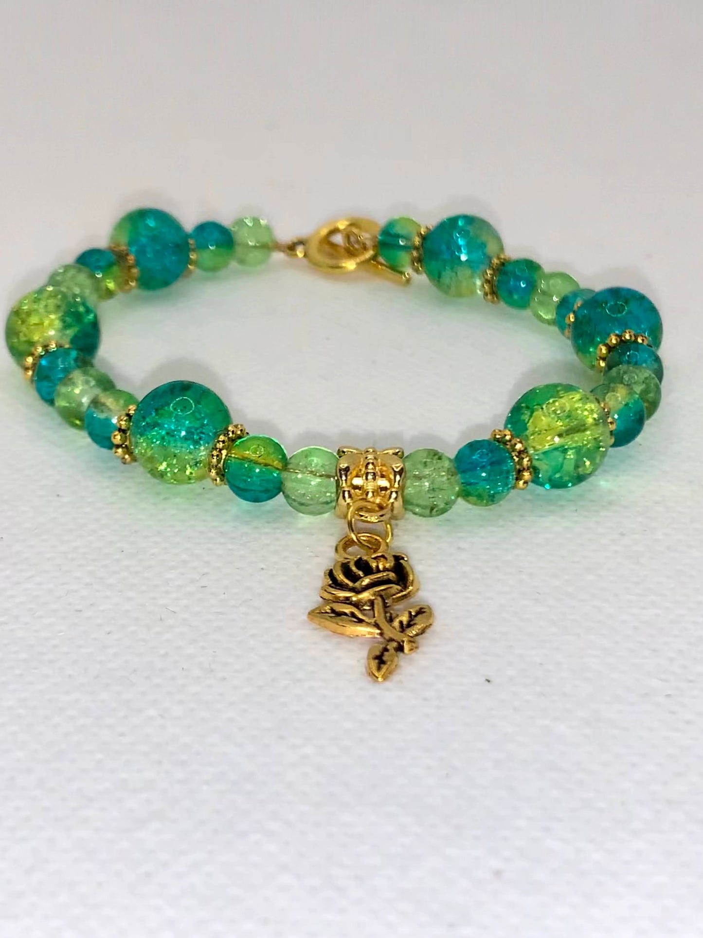 Green/Blue Crackle multi-size beaded bracelet with gold flower and clasp