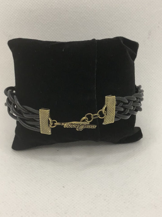 Black braided and brass suede bracelet